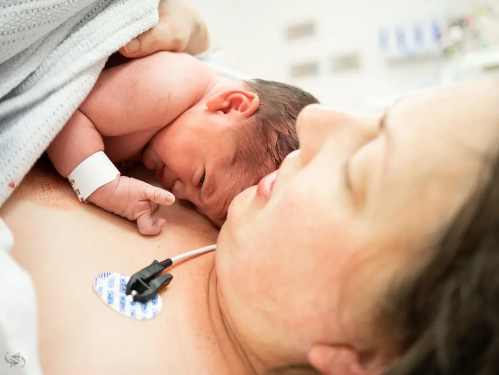 Jess holding baby Maika on her chest after birth.