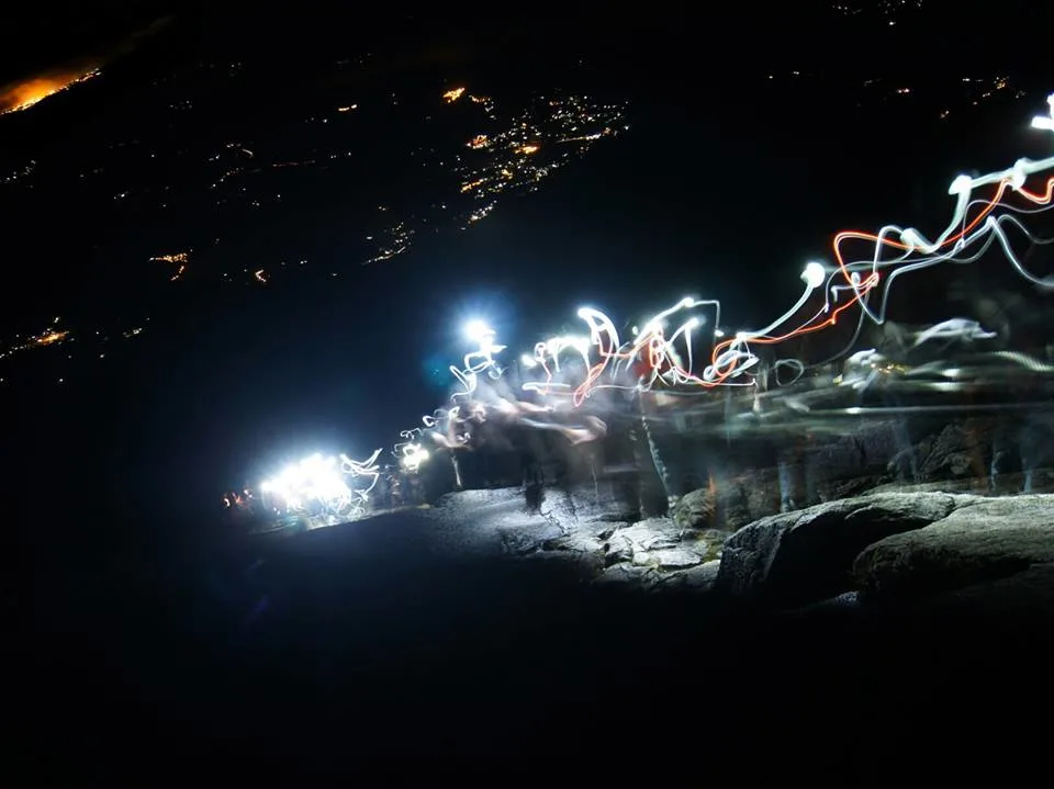 The light trail up the mountain as climbers make the early morning ascent to the summit of Mt Kinabalu in darkness with only flashlights for light.