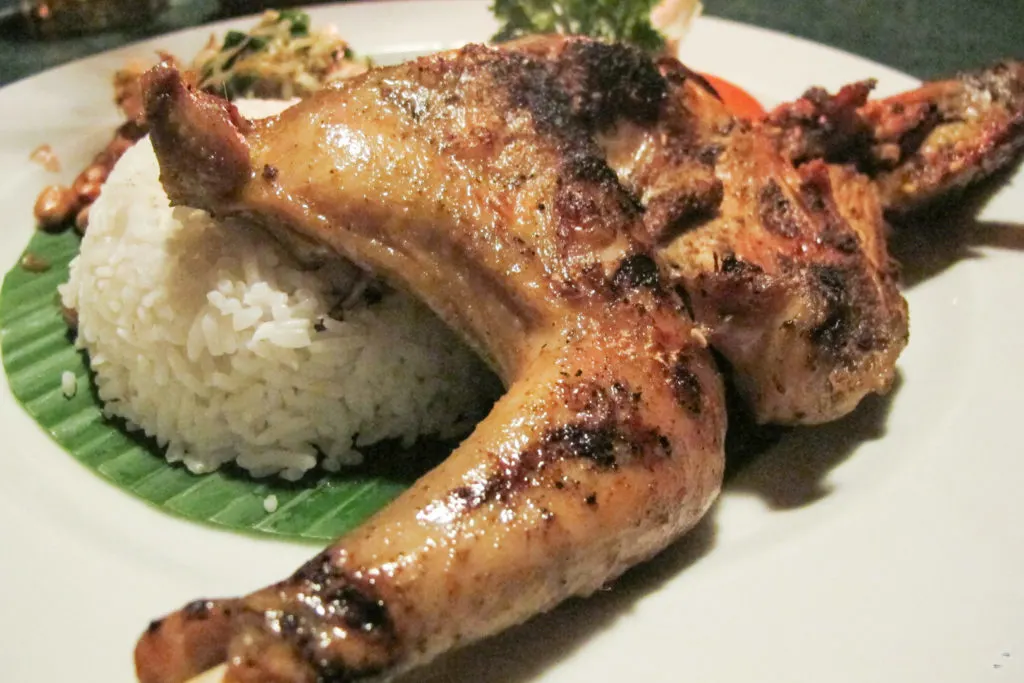 Grilled cock fighting chicken served with rice.