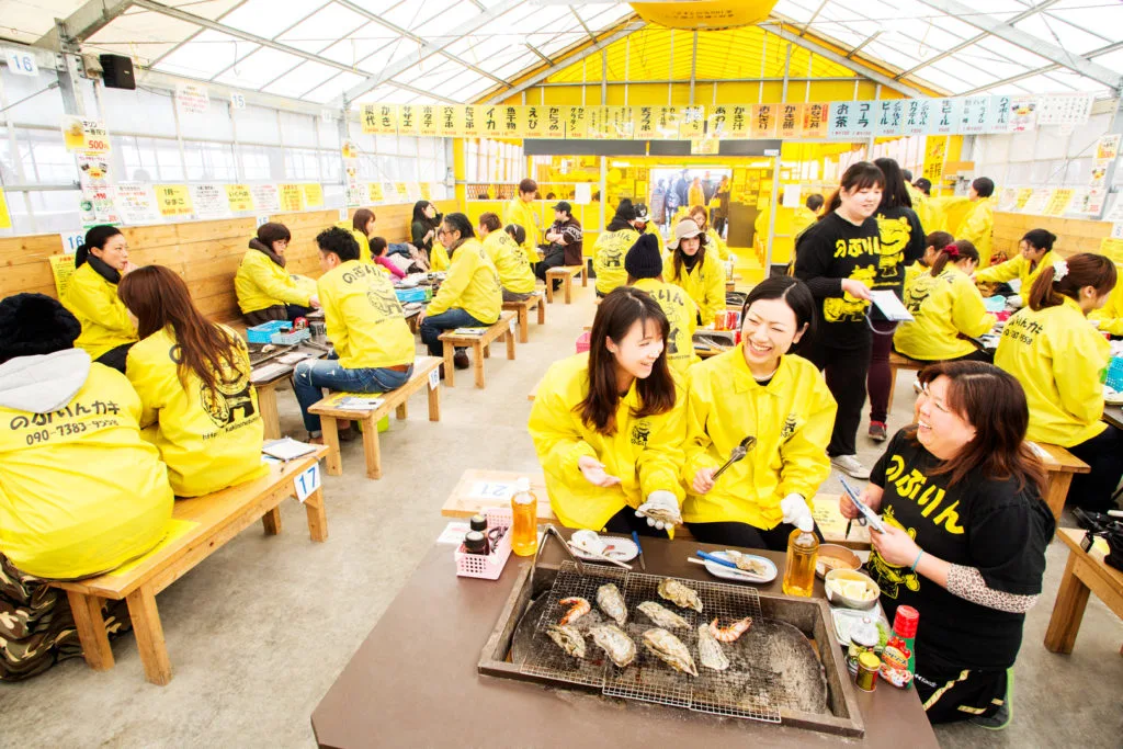 A full house at one of Itoshima's oyster huts where customers are grilling their own oysters at their tables.