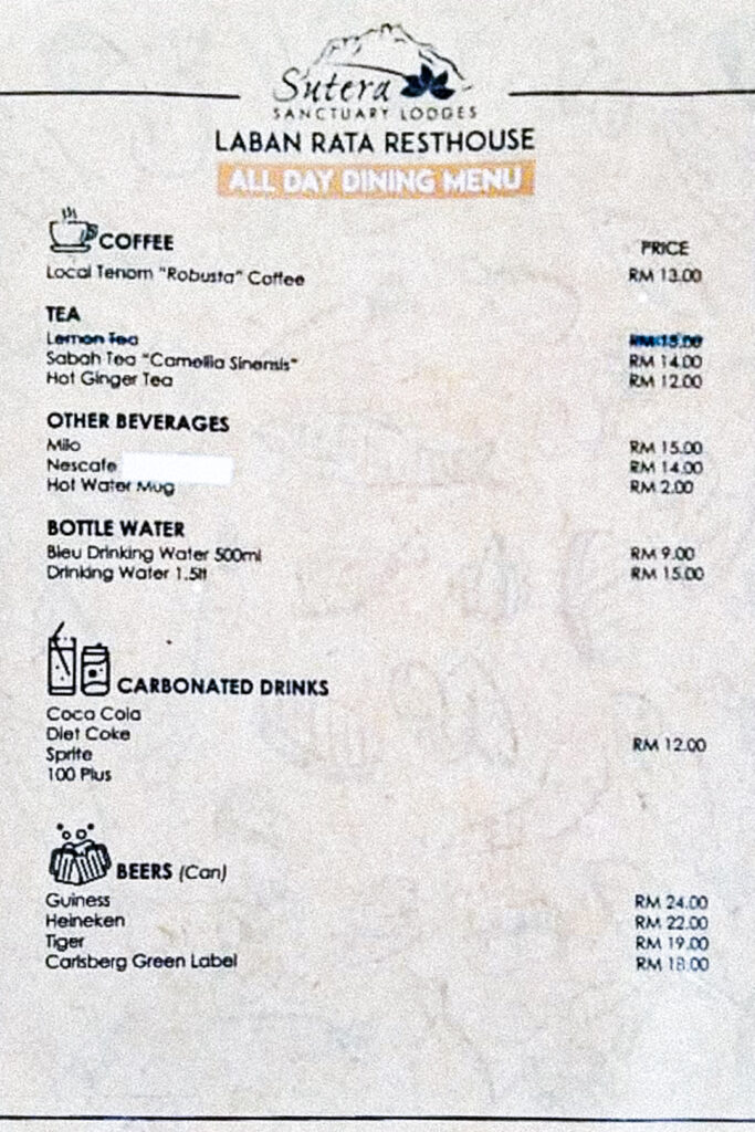 A photo of the Laban Rata drinks menu. Coffee, tea and milo range between RM12 and RM15. Bottled drinking water is RM9 for 500ml and RM15 for 1.5L. Carbonated drinks are RM12 and beer ranges from RM18 to RM24.