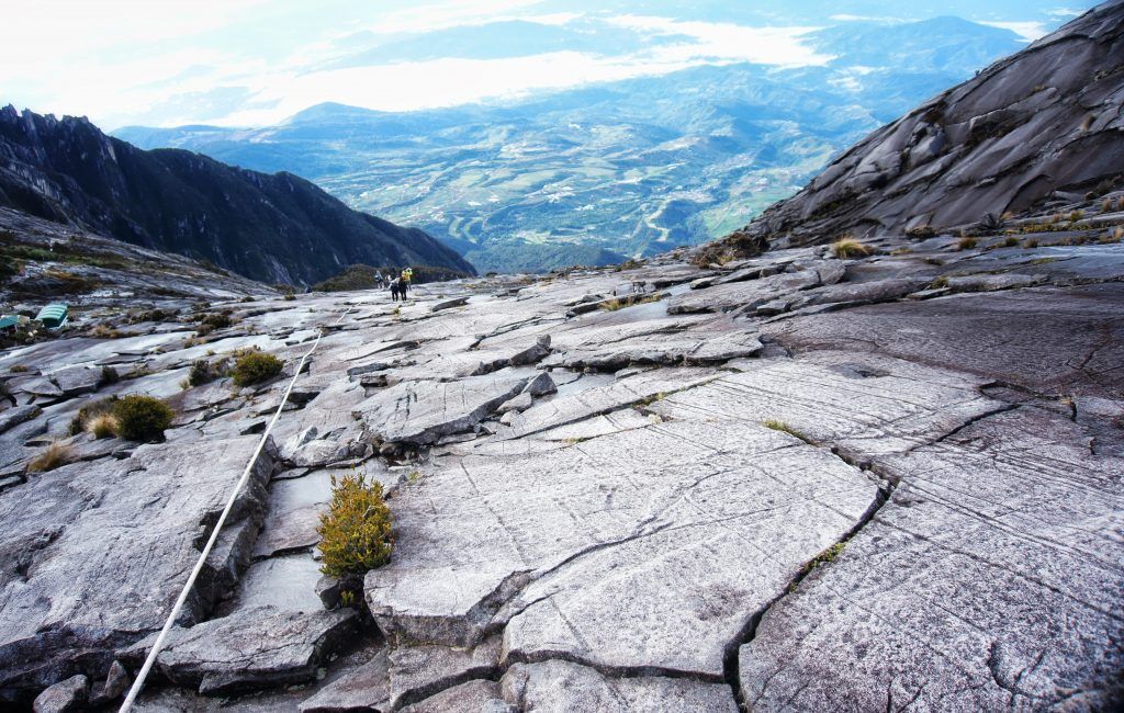 Looking down over the rockface and ropes to help climbers up from the summit of Mt Kinabalu. 