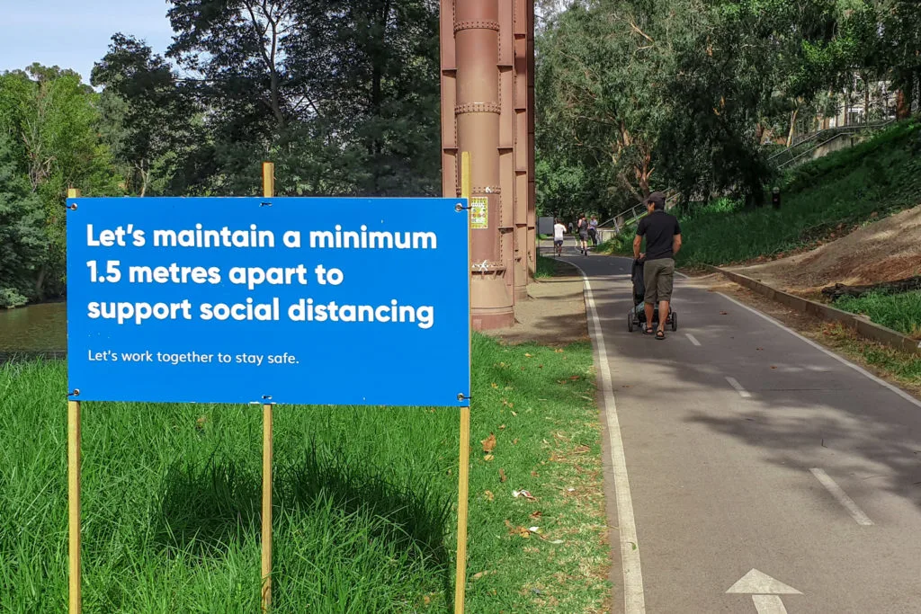 A social distancing sign beside a walking trail in Melbourne.